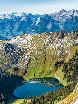 Aerial view of Stockhorn Mountain with alpine lake and surrounding peaks in Switzerland.