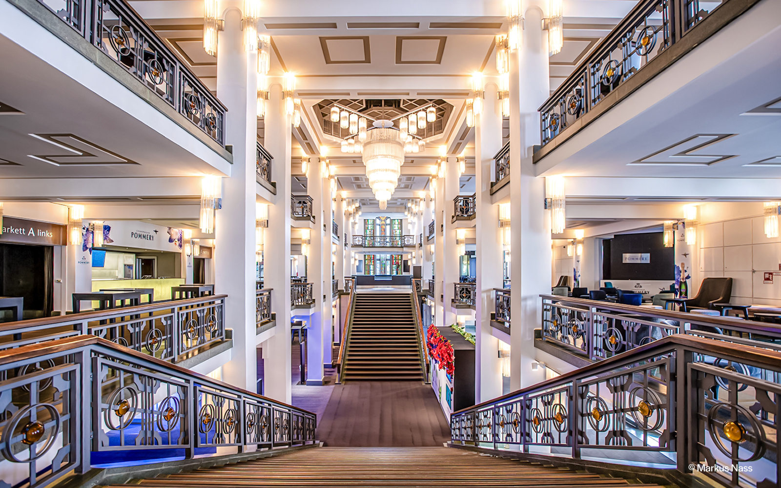 Friedrichstadt Palast interior with grand staircase and chandeliers.