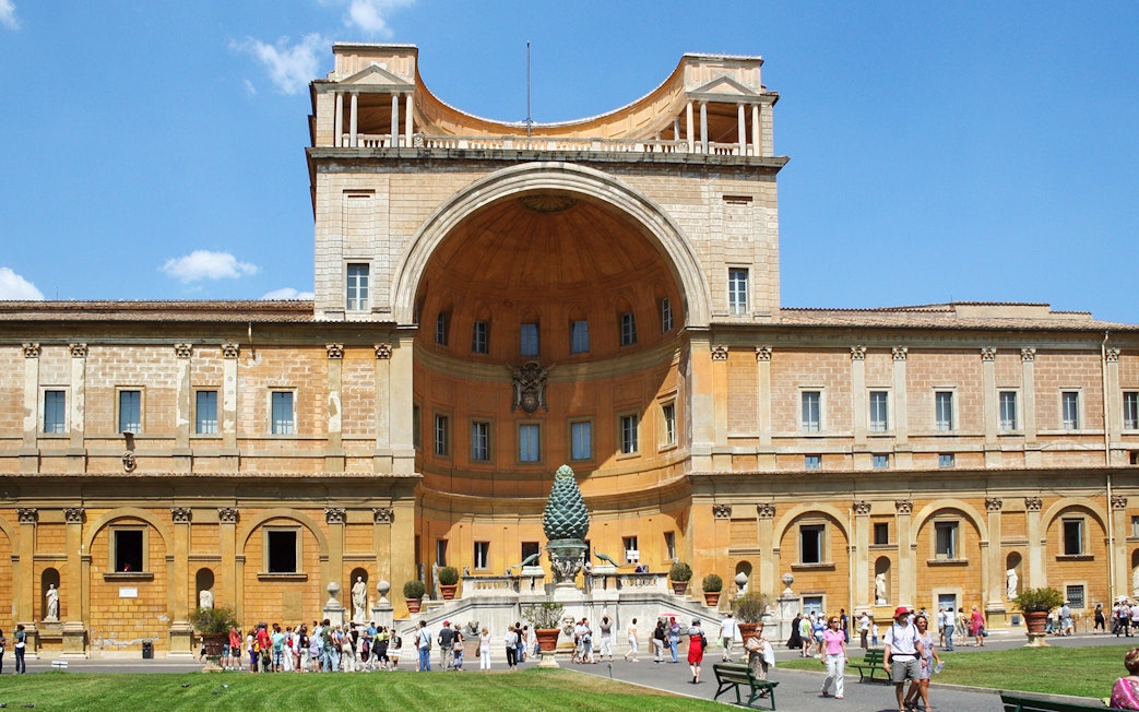 Vatican Museum exterior with courtyard and visitors in Rome, Italy.