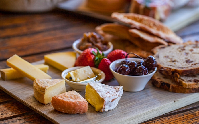 Gourmet cheese and fruit platter on Bruny Island tour.