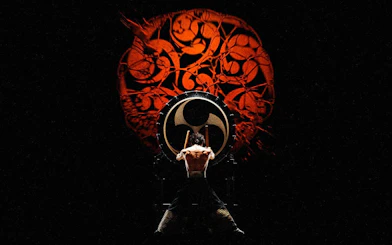 Performer playing taiko drum at DRUM TAO Theater in Kyoto.
