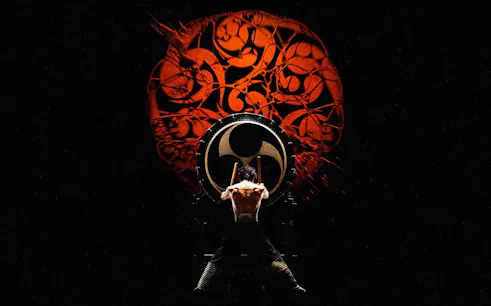 Performer playing taiko drum at DRUM TAO Theater in Kyoto.