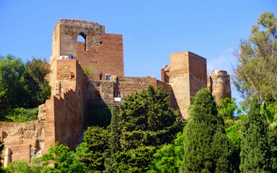 Castillo de Gibralfaro ruins with visitors, Málaga, Costa del Sol, Andalusia, Spain.