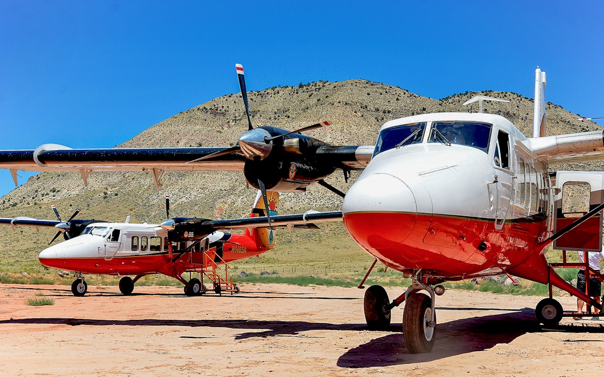 Twin-engine planes on the ground at North Rim, ready for helicopter tour.