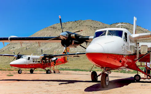 Twin-engine planes on the ground at North Rim, ready for helicopter tour.