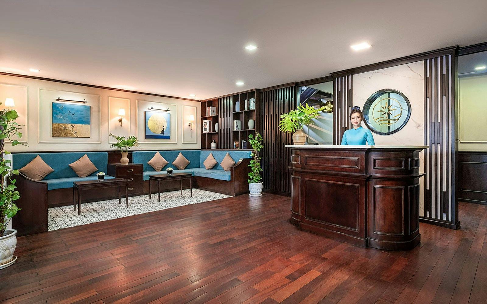 Reception area with wooden desk and seating at Amanda Luxury Cruise.