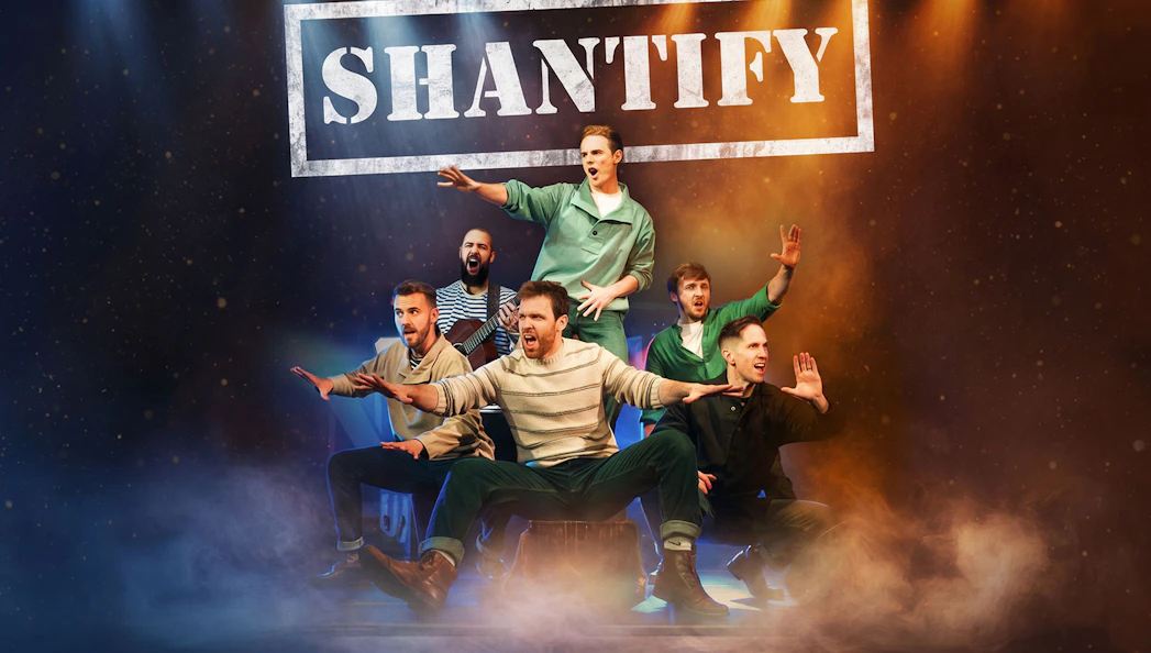 Performers on stage at Shantify Westend show, with dramatic lighting and expressive poses.