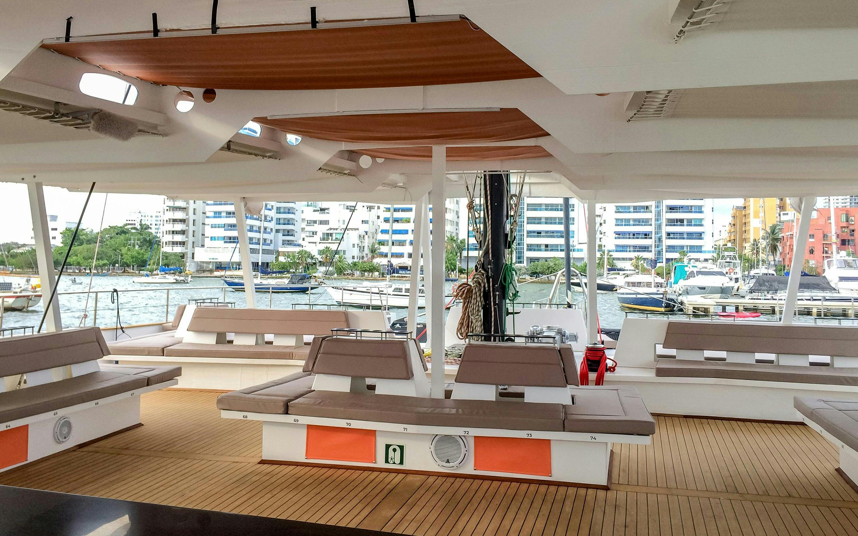 Catamaran deck with seating and marina view in Cartagena.