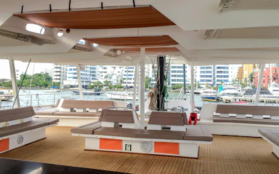 Catamaran deck with seating and marina view in Cartagena.