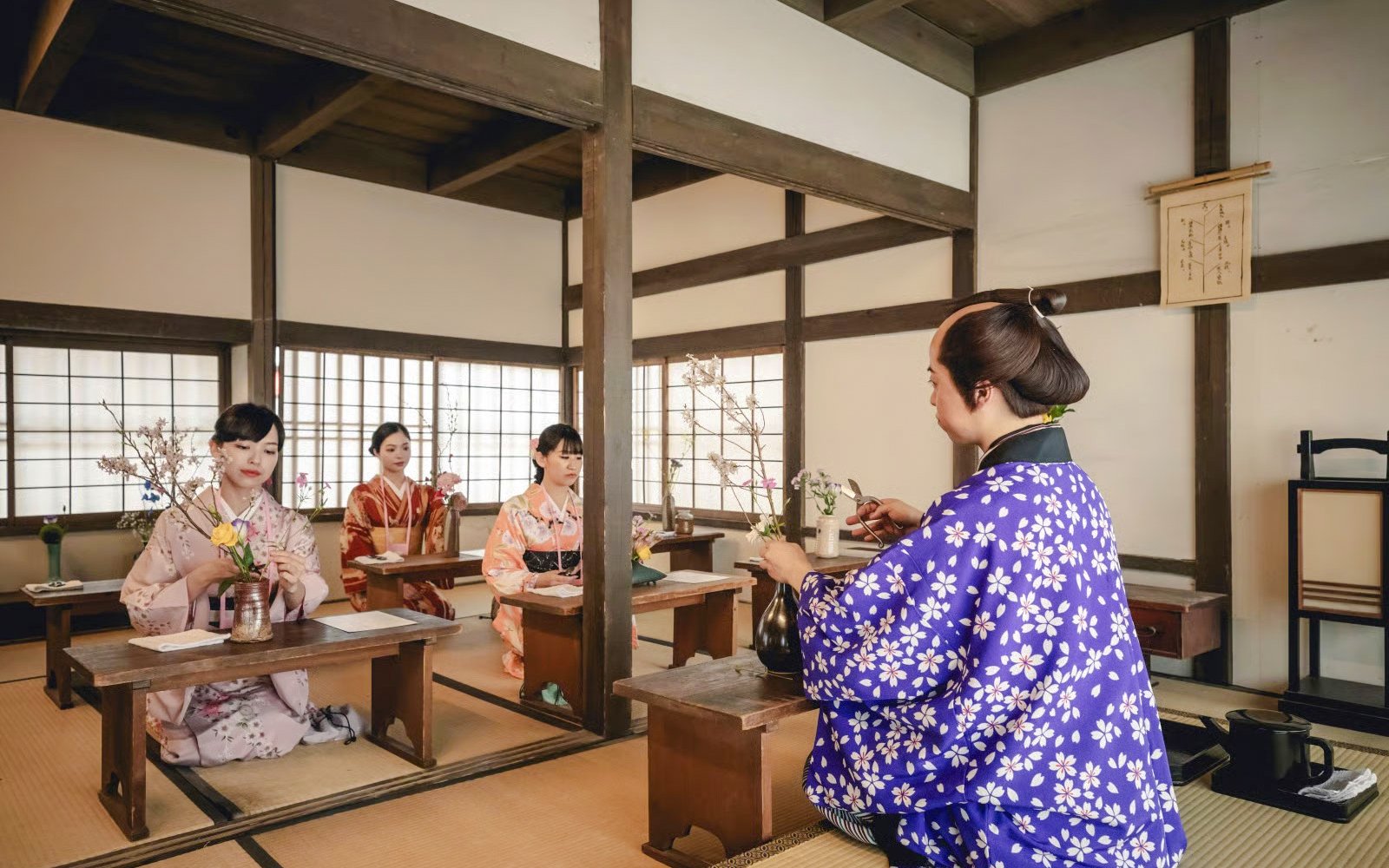 Tea ceremony at TOEI Kyoto Studio Park with participants in traditional attire.
