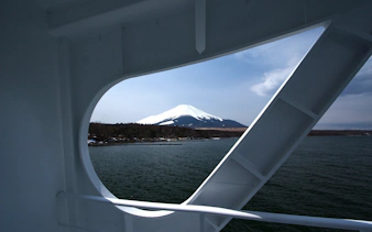 View of Mount Fuji from Lake Yamanaka cruise ship window.