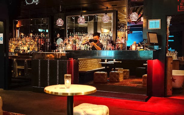 Bartender preparing cocktails at a hidden bar in Melbourne.