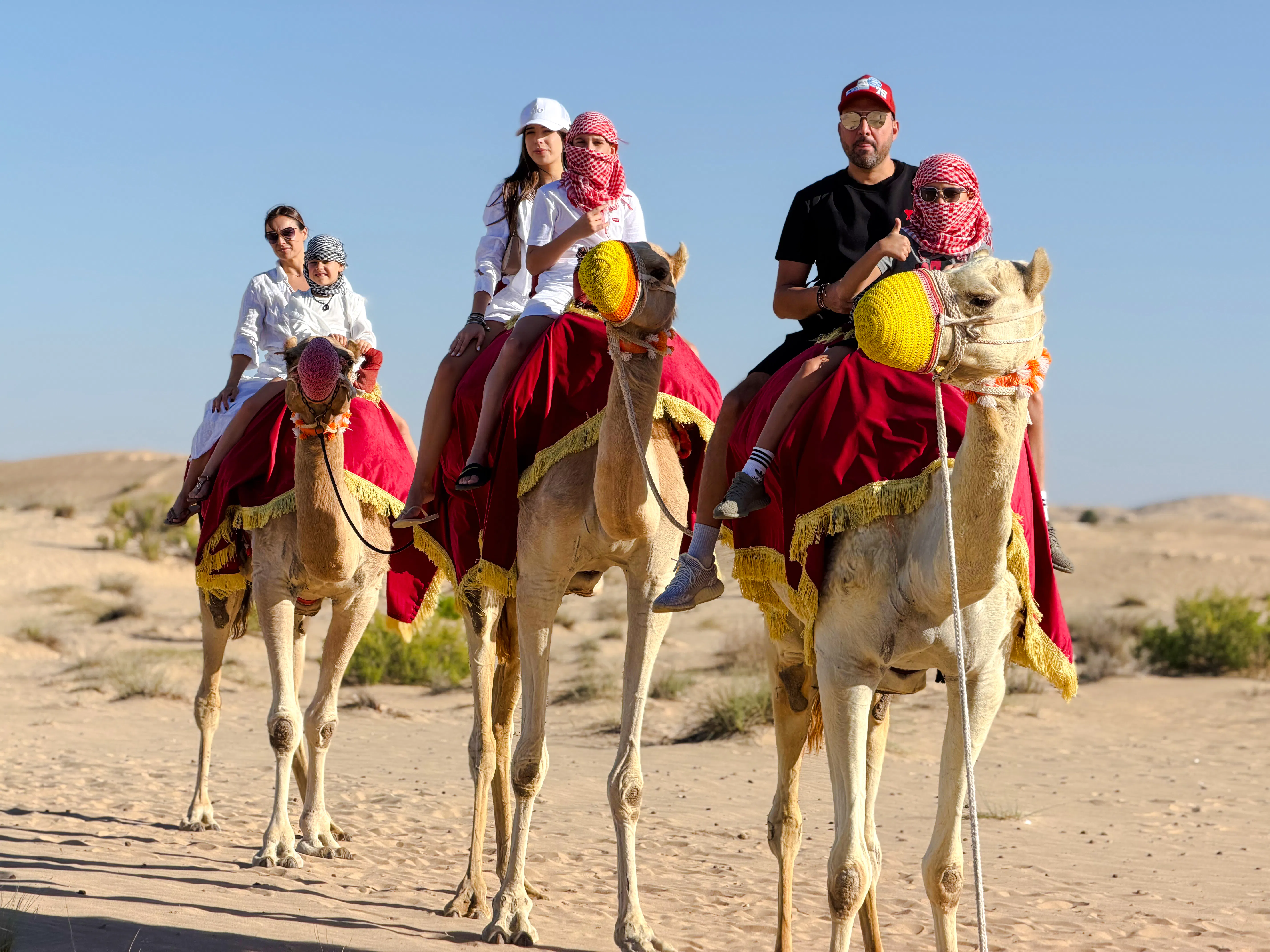 Camel ride during evening desert safari in Abu Dhabi.