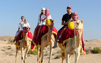 Camel ride during evening desert safari in Abu Dhabi.