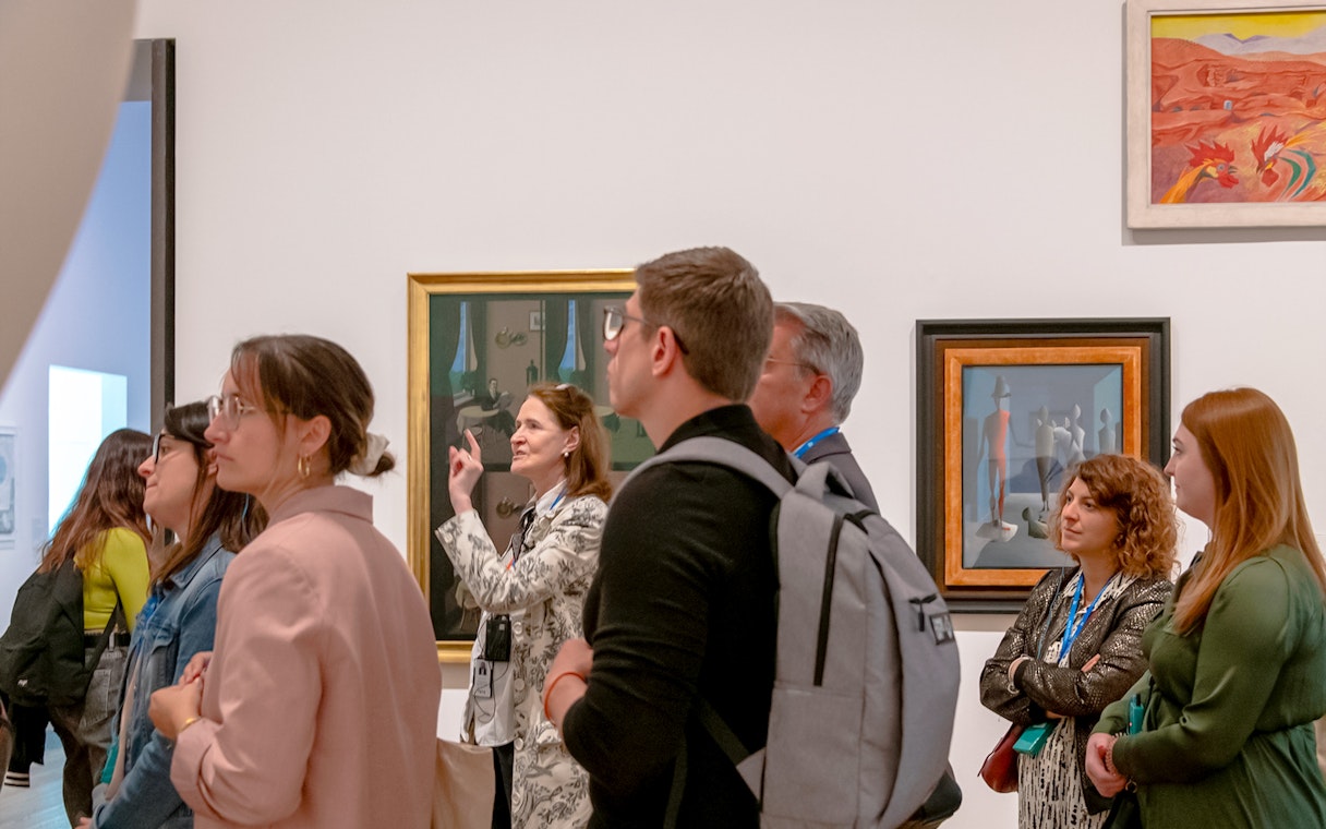 Guide explaining Picasso exhibition at Tate Modern to a group of visitors.