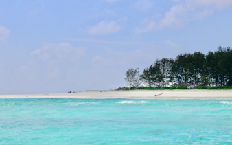 Turquoise waters and sandy beach of Mnemba Island Atoll, Zanzibar.