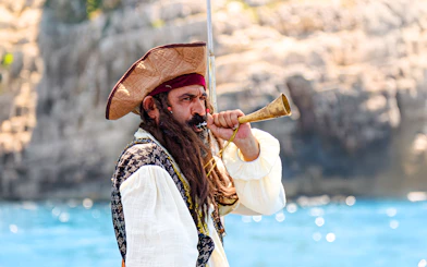 Pirate blowing horn on Vlora Ionian Odyssey boat tour, Albania.