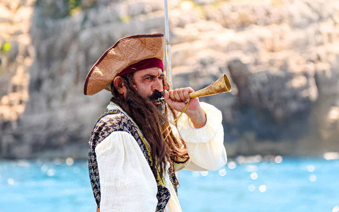 Pirate blowing horn on Vlora Ionian Odyssey boat tour, Albania.