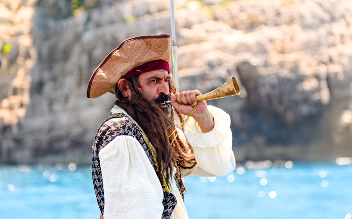 Pirate blowing horn on Vlora Ionian Odyssey boat tour, Albania.