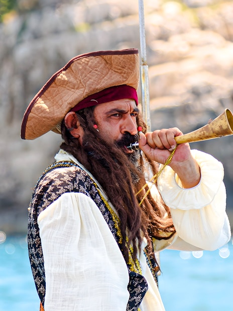 Pirate blowing horn on Vlora Ionian Odyssey boat tour, Albania.