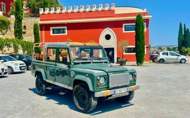 Land Rover parked outside a historic château in Nice for a wine tasting tour.