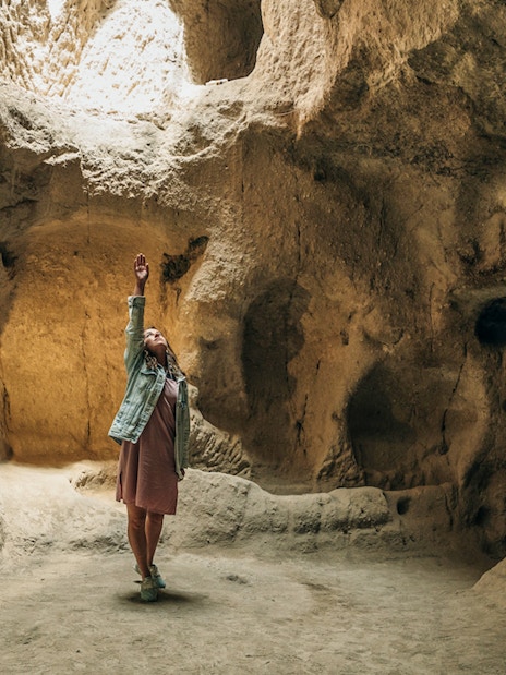 Young tourist woman exploring Derinkuyu underground cave city.