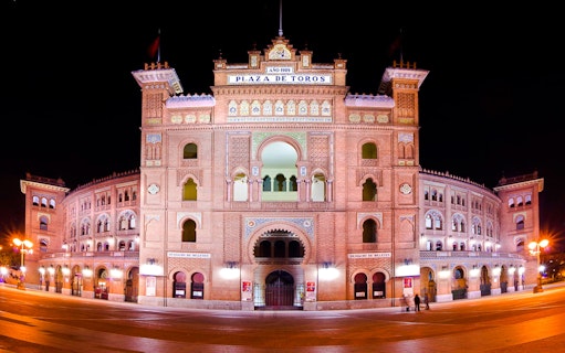 Plaza de Toros de Las Ventas illuminated at night in Madrid, Spain.