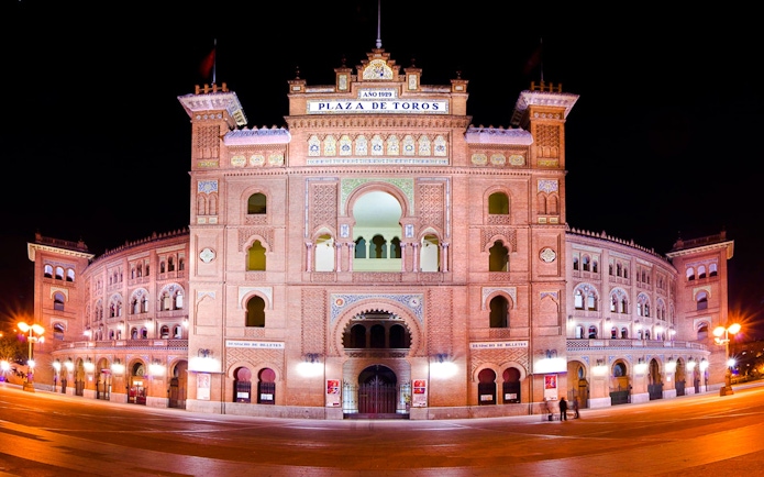 Plaza de Toros de Las Ventas illuminated at night in Madrid, Spain.