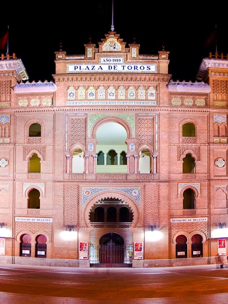 Plaza de Toros de Las Ventas illuminated at night in Madrid, Spain.