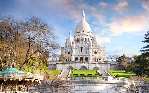 Sacré-Cœur Basilica with carousel in Montmartre, Paris, during a tour.