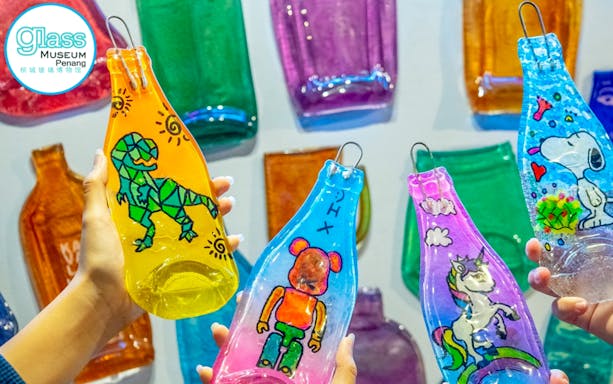 Decorated glass bottles with colorful designs at Glass Museum Penang.