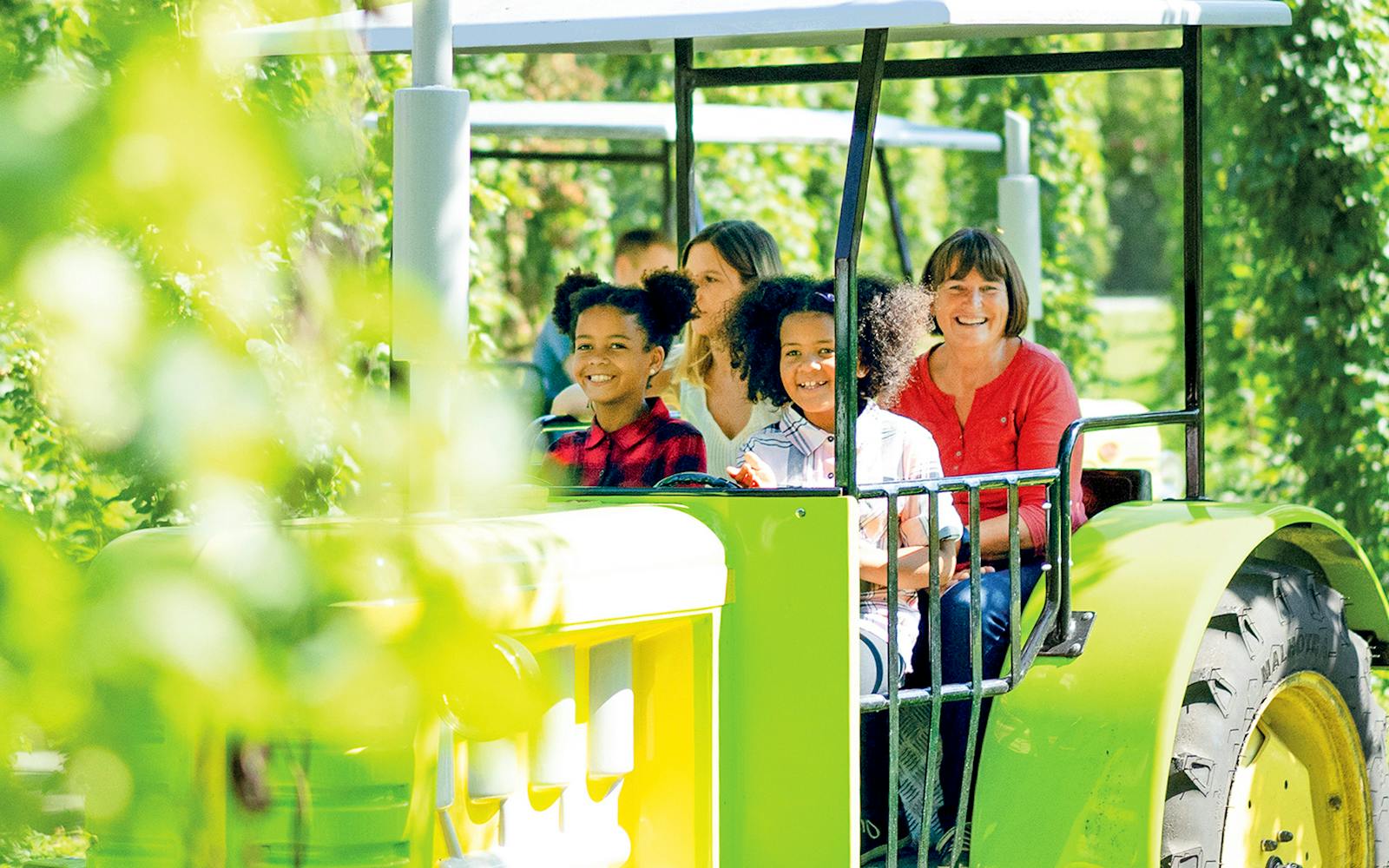 Visitors enjoying a tractor ride at Ravensburger Spieleland.