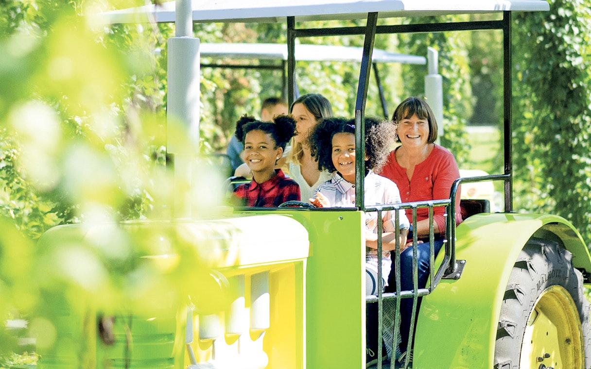 Visitors enjoying a tractor ride at Ravensburger Spieleland.