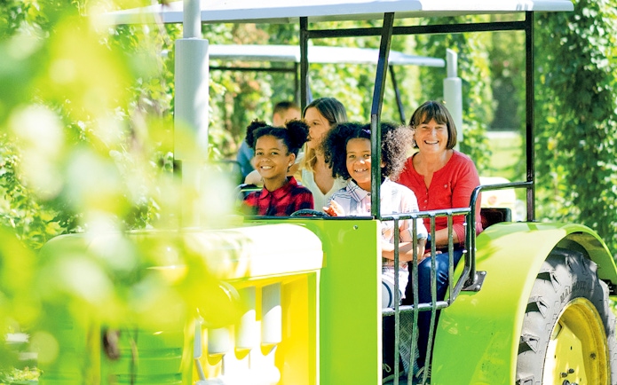 Visitors enjoying a tractor ride at Ravensburger Spieleland.