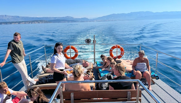 Group enjoying a boat cruise on the Blue Lagoon Šolta with scenic views of the Adriatic Sea.