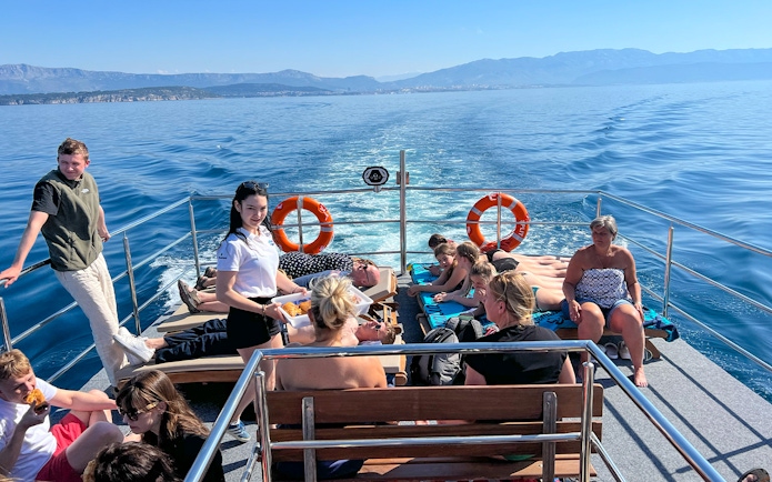 Group enjoying a boat cruise on the Blue Lagoon Šolta with scenic views of the Adriatic Sea.