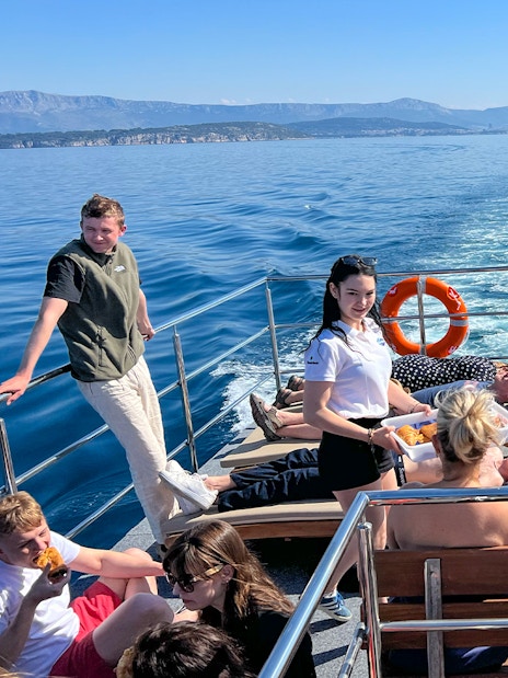 Group enjoying a boat cruise on the Blue Lagoon Šolta with scenic views of the Adriatic Sea.