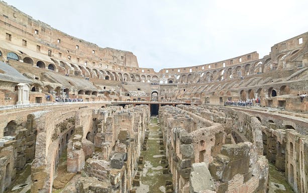 Colosseum underground ruins with ancient stone arches and pathways in Rome, Italy.