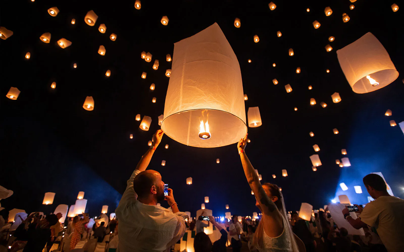 Lanterns released into the night sky at Yeepeng Lanna Festival 2023 in Thailand.