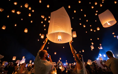 Lanterns released into the night sky at Yeepeng Lanna Festival 2023 in Thailand.