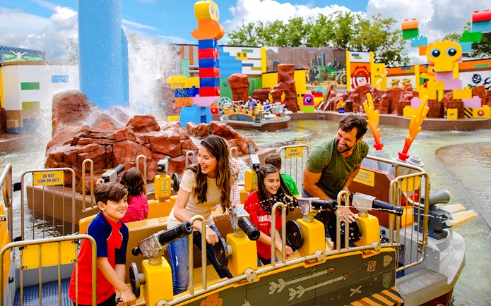 Visitors enjoying water cannons at Battle of Bricksburg ride, Legoland Florida.