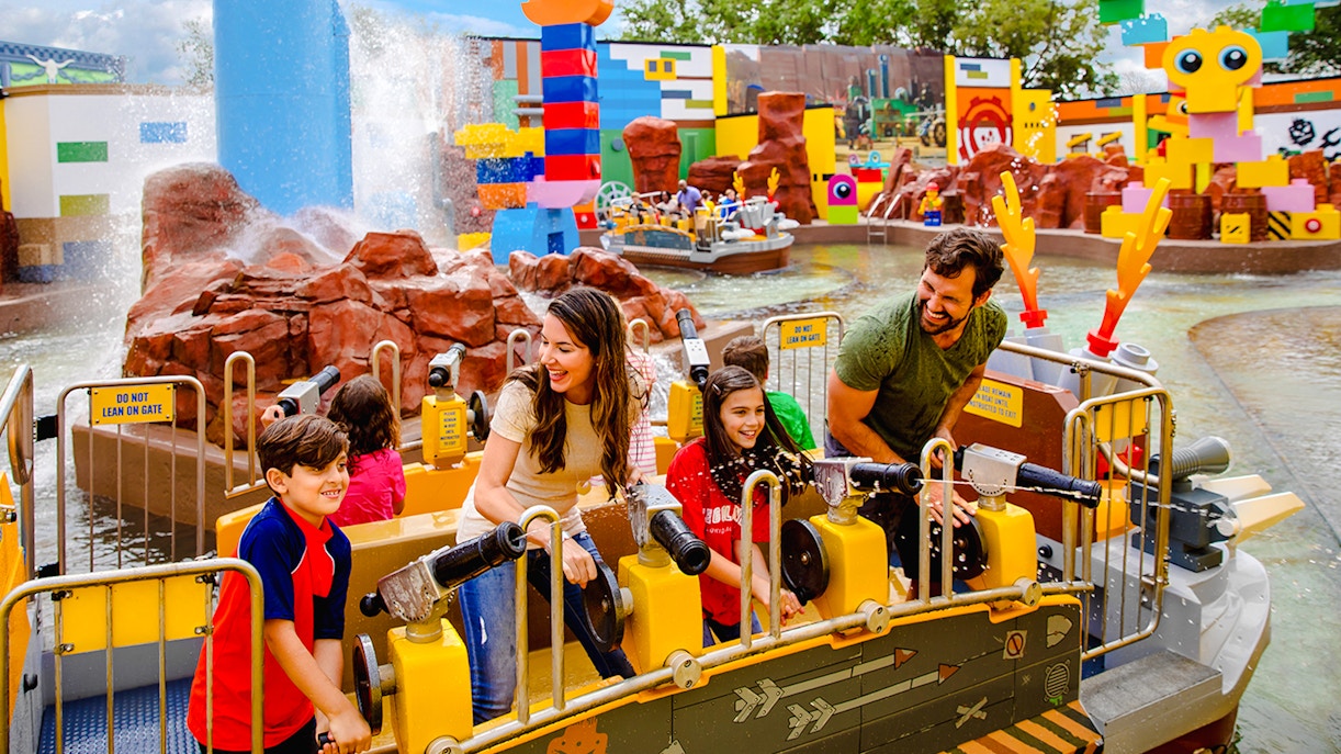 Visitors enjoying water cannons at Battle of Bricksburg ride, Legoland Florida.