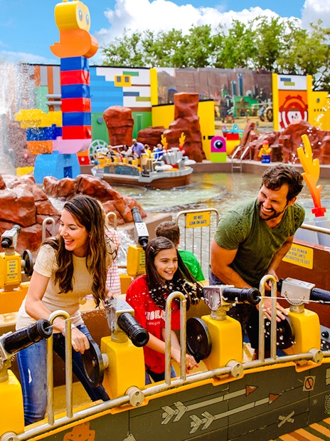 Visitors enjoying water cannons at Battle of Bricksburg ride, Legoland Florida.