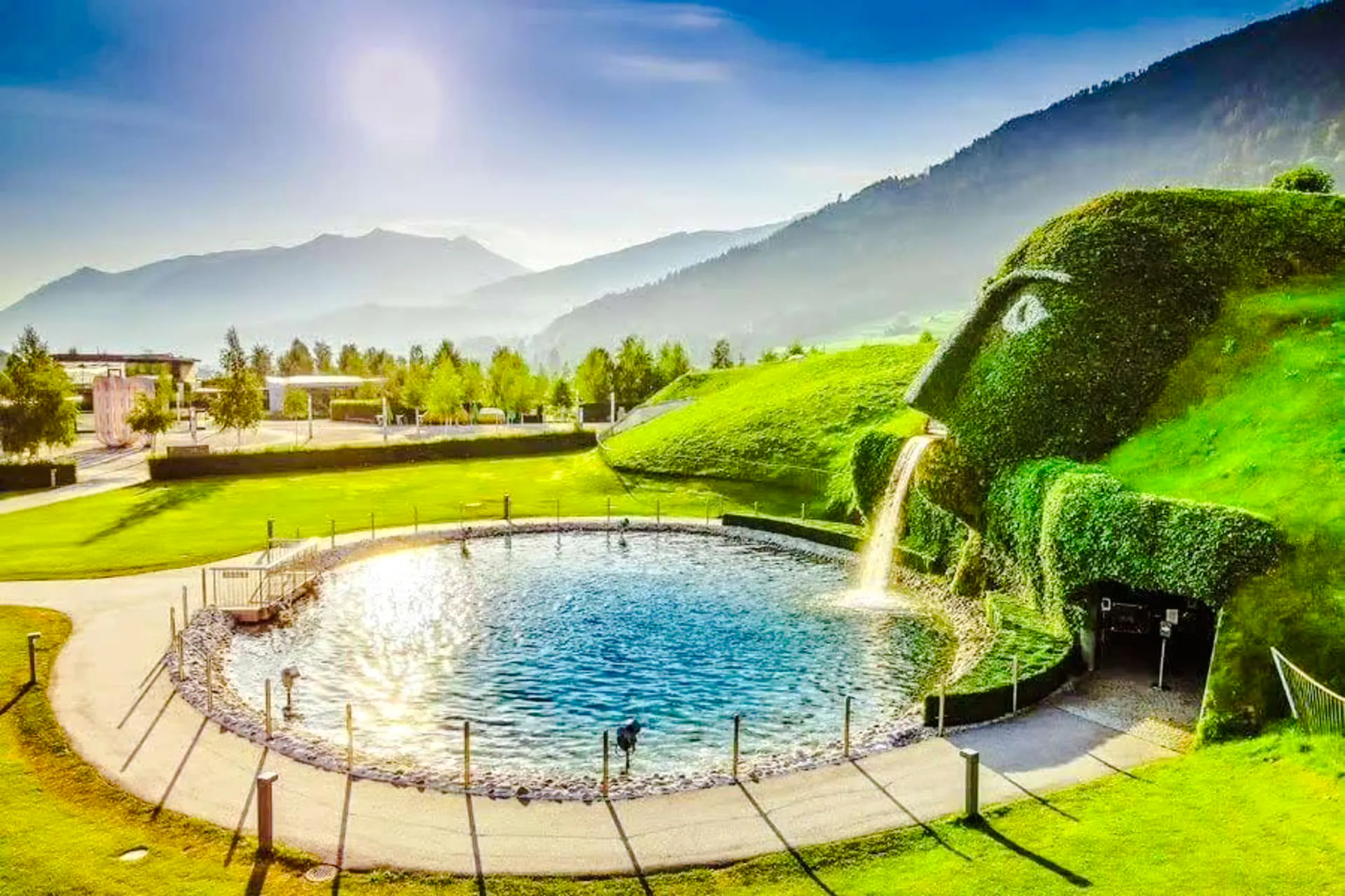 Swarovski Crystal Worlds entrance with water feature and mountain backdrop, Innsbruck.