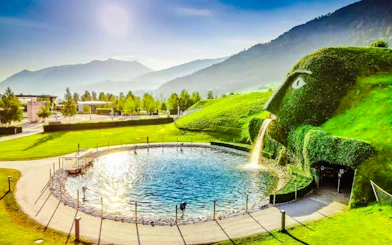 Swarovski Crystal Worlds entrance with water feature and mountain backdrop, Innsbruck.