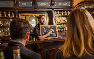Guests learning about whiskey distillation at the Irish Whiskey Museum tour.