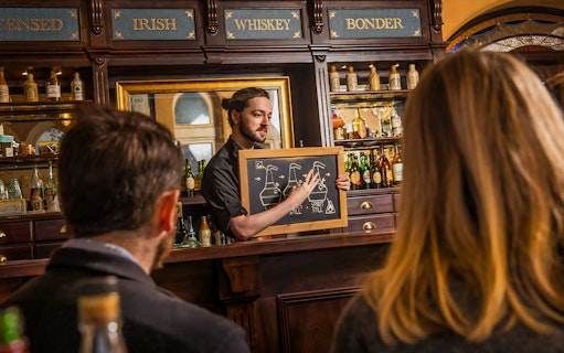 Guests learning about whiskey distillation at the Irish Whiskey Museum tour.