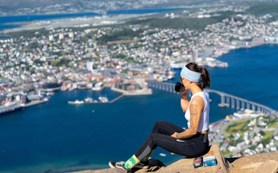 Tourist enjoying the view of Tromsø from Fjellheisen summit.