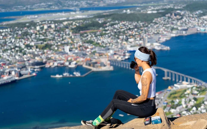 Tourist enjoying the view of Tromsø from Fjellheisen summit.
