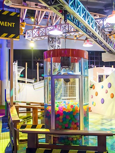 Interactive play area at KidsSTOP Singapore with colorful structures and ball pit.